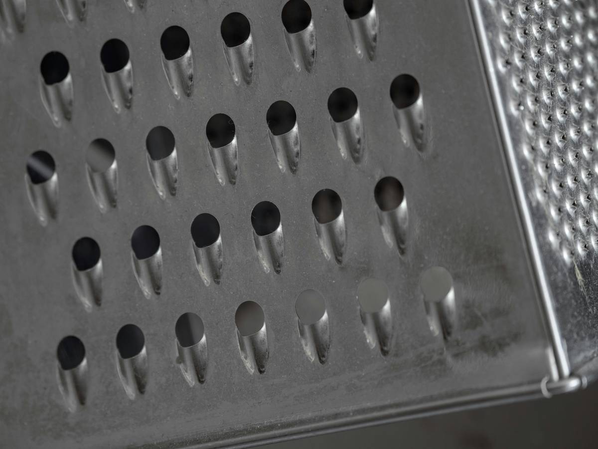 Close-up of potato peelers stainless steel blades showing sharp edges and ergonomic handles